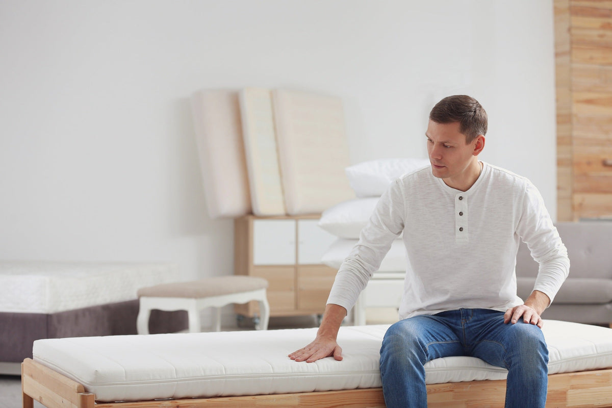 man sitting on a mattress