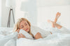 woman lying on bamboo sheets