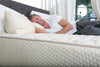 man sleeping on his side on a latex mattress