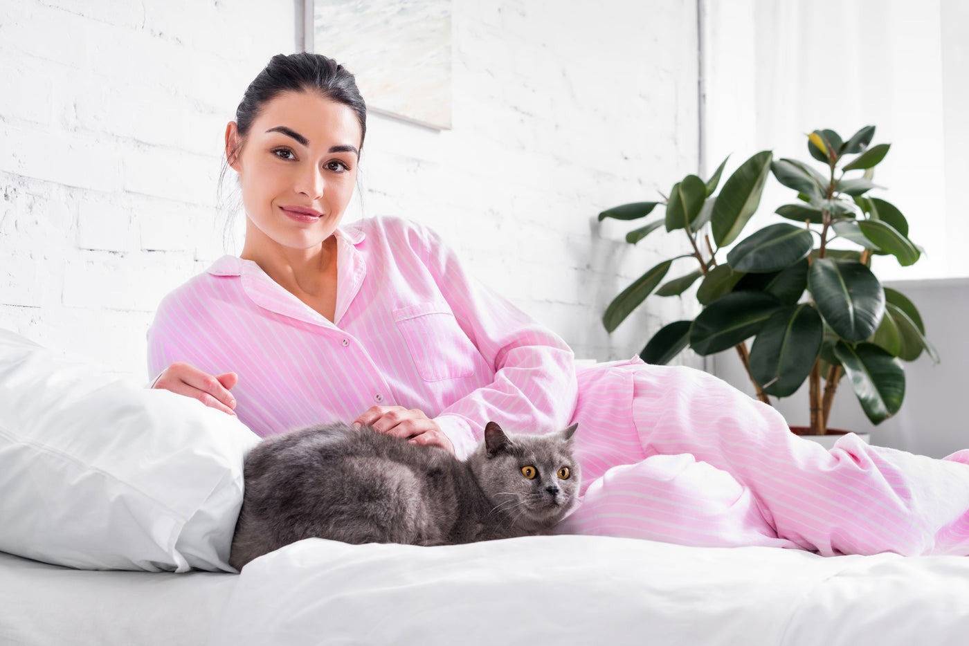 woman on bed with cat