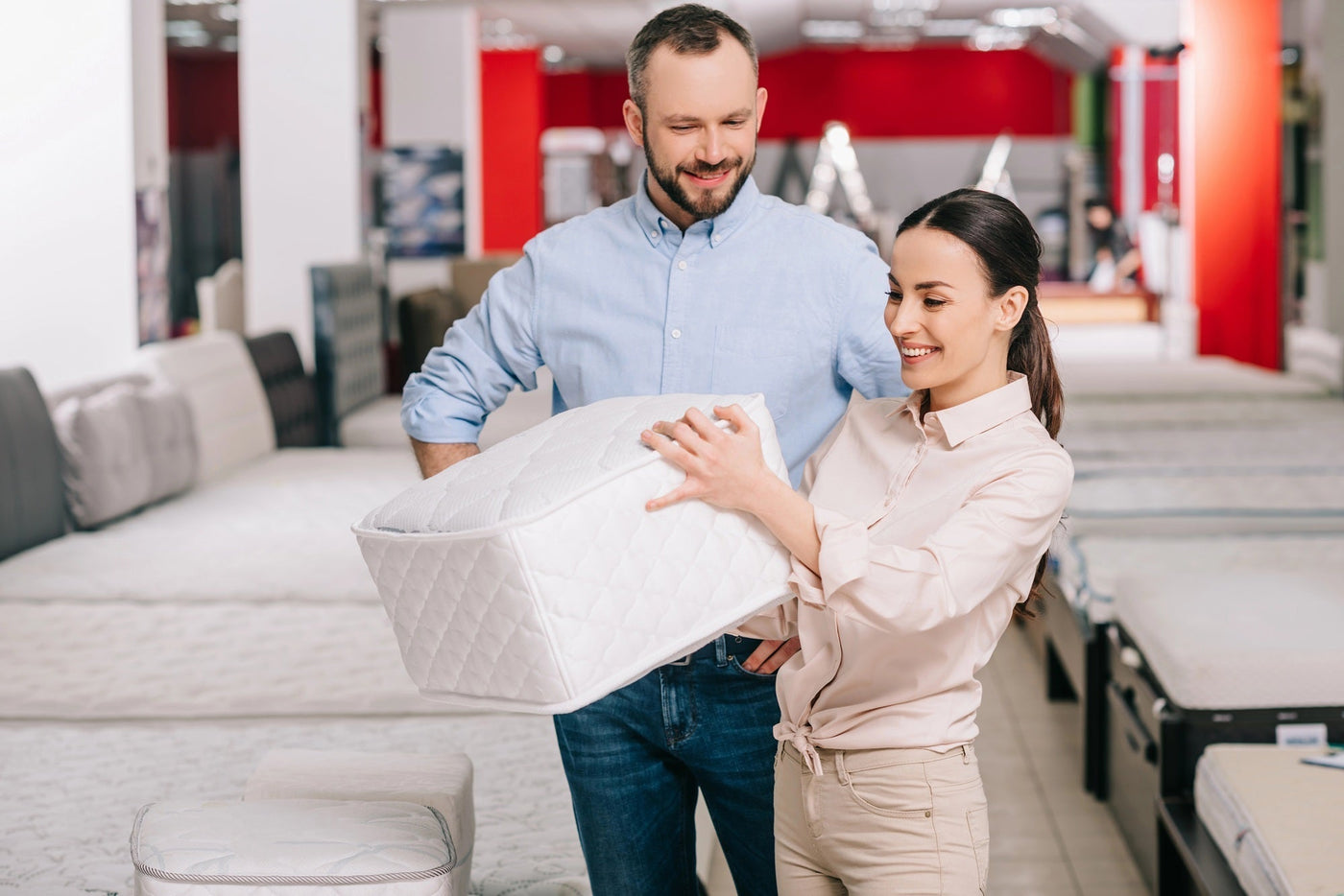 couple testing mattress firmness